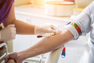 Nurse taking a patient's blood sample at lab