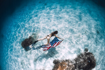 Free diver swim over sandy sea with United States flag. Independence day concept