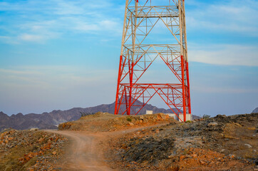 Dirt Road near a red & white Mobile Tower on a hilltop. From Muscat, Oman.