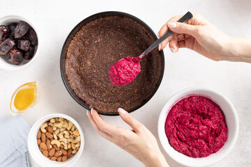 female hands cooking vegan beetroot cake. Clean eating, plant based diet concept. White background. flat lay. selective focus