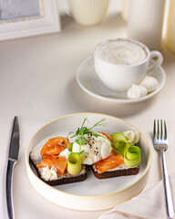 serving sandwich with fish and egg coffee