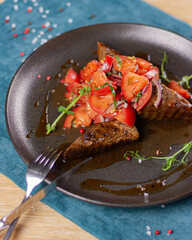 tomato salad on a dark plate