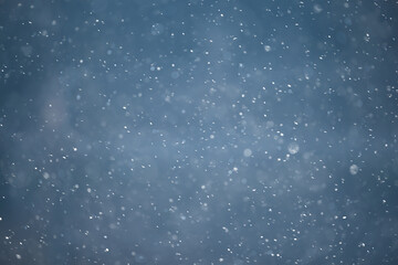 Naklejka na ściany i meble blue snowfall bokeh background, abstract snowflake background on blurred abstract blue