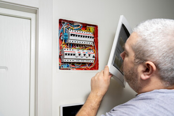 Electricity distribution box. Fuse box. man doing electrical work