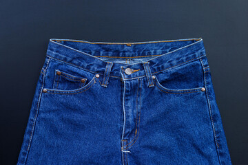 Blue jeans on dark background.