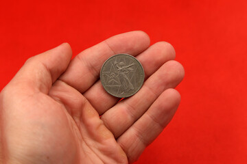The soviet coin ruble in hand on red background
