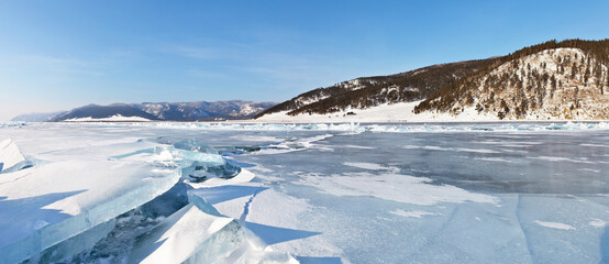 Beautiful winter landscape of frozen Lake Baikal with ice hummocks and ice breaks. The Great Baikal...