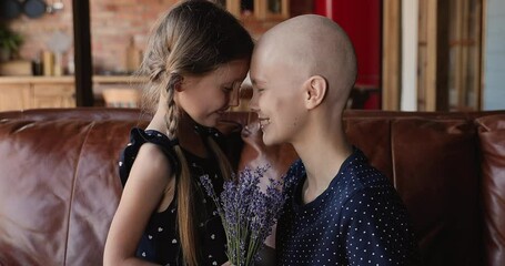 Loving daughter make surprise for mom cancer patient gives her lavender bunch congratulates wish remission recovery oncology disease. Mother Day, birthday event celebration, love and support concept