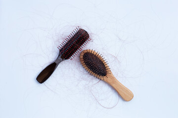 Hairs loss fall in combs on white