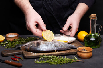 Process of cooking dorado fish with lemon and herbs.