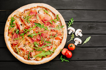 Delicious pizza with ham and cheese on wooden background