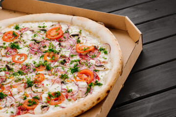 Tasty fresh pizza with ingredients on wooden background