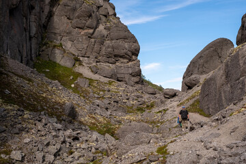 tourists are walking along a mountain trail