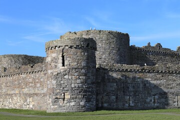 Fototapeta na wymiar The 13th century stone walls and turrets of Beaumaris Castle, Isle of Anglesey, Wales, UK.
