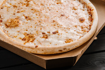 Tasty fresh cheese pizza on wooden background