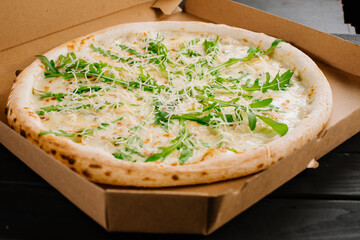 Fresh tasty pizza on black wooden background
