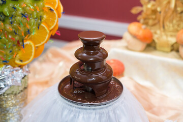 Chocolate fountain on a restaurant table in celebration
