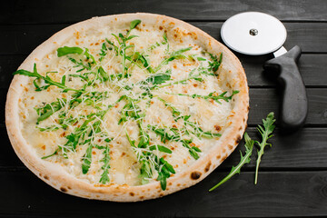 Fresh tasty pizza on black wooden background