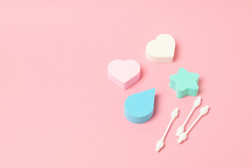 Makeup sponges or beauty blenders on pink background, beauty concept