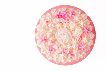 cake with pink meringue on a white background. The view from the top