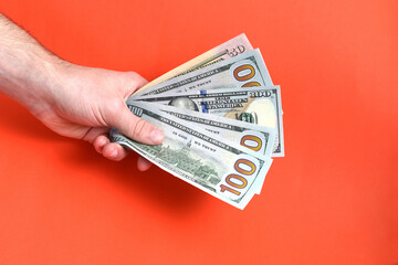 Hand holding money usa dollar on red background