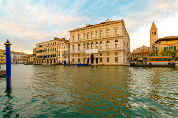 Fototapeta na wymiar Beautiful panorama of the Grand Canal during a summer day with blue sky and clouds. In the background the Palazzo Grassi in the Venetian lagoon, Venice, Italy.