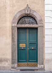 vintage residential building entrance arched green door, Rome Italy