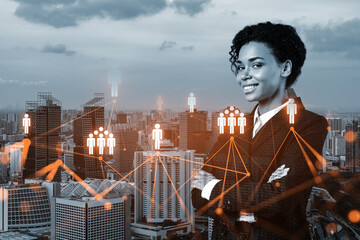 Smiling black woman HR director at international company is thinking about recruitment of highly qualified specialists. Women in business concept. Social media hologram icons over Singapore.