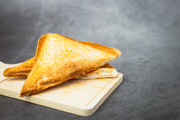 Sandwich bread on dark background for bakery, food and eating concept