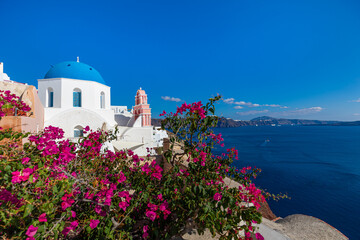 Fototapeta premium Santorini island, Greece. Amazing summer vacation landscape, white architecture and blue sea view over the caldera. Famous travel destination, urban travel background. Leisure lifestyle travelling