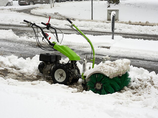 Selective focus. Close-up of a sidewalk snow removal machine Winter attack in Germany. Heavy...