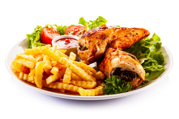 Stuffed chicken fillets, French fries and fresh vegetables
on white background
