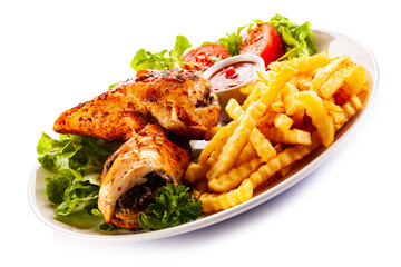 Stuffed chicken fillets, French fries and fresh vegetables
on white background