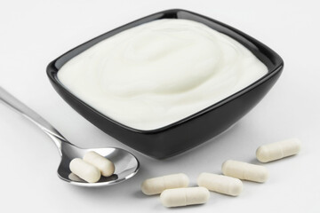 Fototapeta na wymiar Probiotic capsules and natural yoghurt