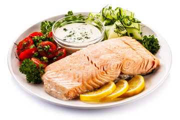 Fried salmon steak with fresh vegetables on white background