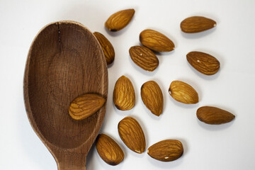 nuts in spoon on white isolated background with copy space