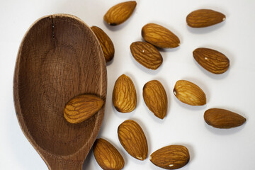 nuts in spoon on white isolated background with copy space
