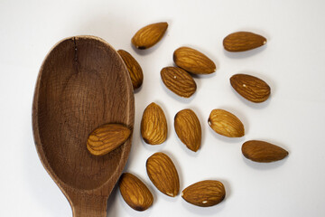 nuts in spoon on white isolated background with copy space