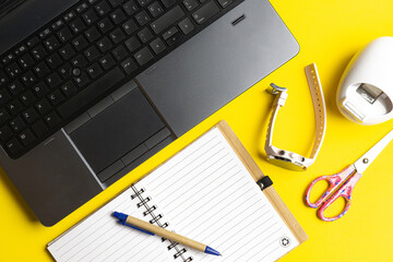 top view of workspace with notebook laptop and tape scissors and smart watch. technology concept. flat lay flat design.