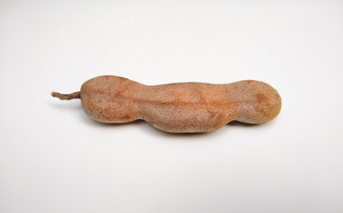 Tamarind (Tamarindus indica) fruit isolated on white background