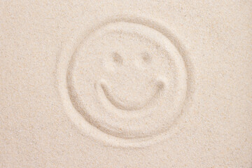 Smile face handwriting in sand above view macro