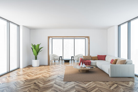 White and wooden living room with sofa and armchairs, parquet floor