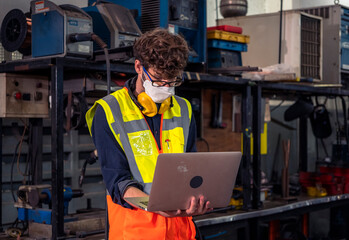 Engineers wear masks to prevent COVID-19 infection. While working in the factory