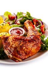 Roast chicken leg with boiled potatoes on white background
