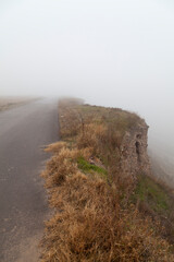 Foggy landscape from the top of a hill, with lonely asphalt roads, near Gallur, a town in the...