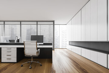 White office room with table and computer, window with city view