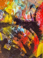 Abstract texture with yellow, red, black tempera paints on the palette.