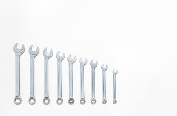 Set of wrenches different size on white background with copy space, text place. Banner with instruments kit for repair car. Business card for tools shop. Close up. Size line. Flat lay. Layout. Mockup
