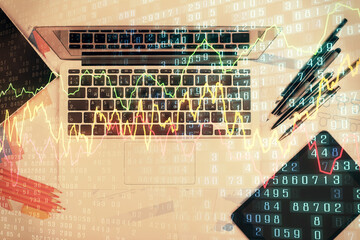 Multi exposure of forex chart drawing over table background with computer. Concept of financial research and analysis. Top view.