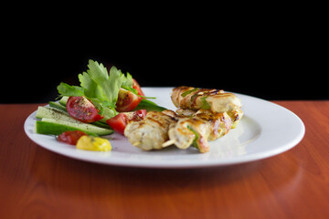 Chicken shish kebab, grilled chicken with greens and tomato